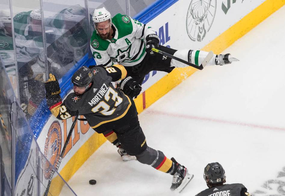 Dallas Stars' Blake Comeau (15) is checked by Vegas Golden Knights' Alec Martinez (23) during t ...