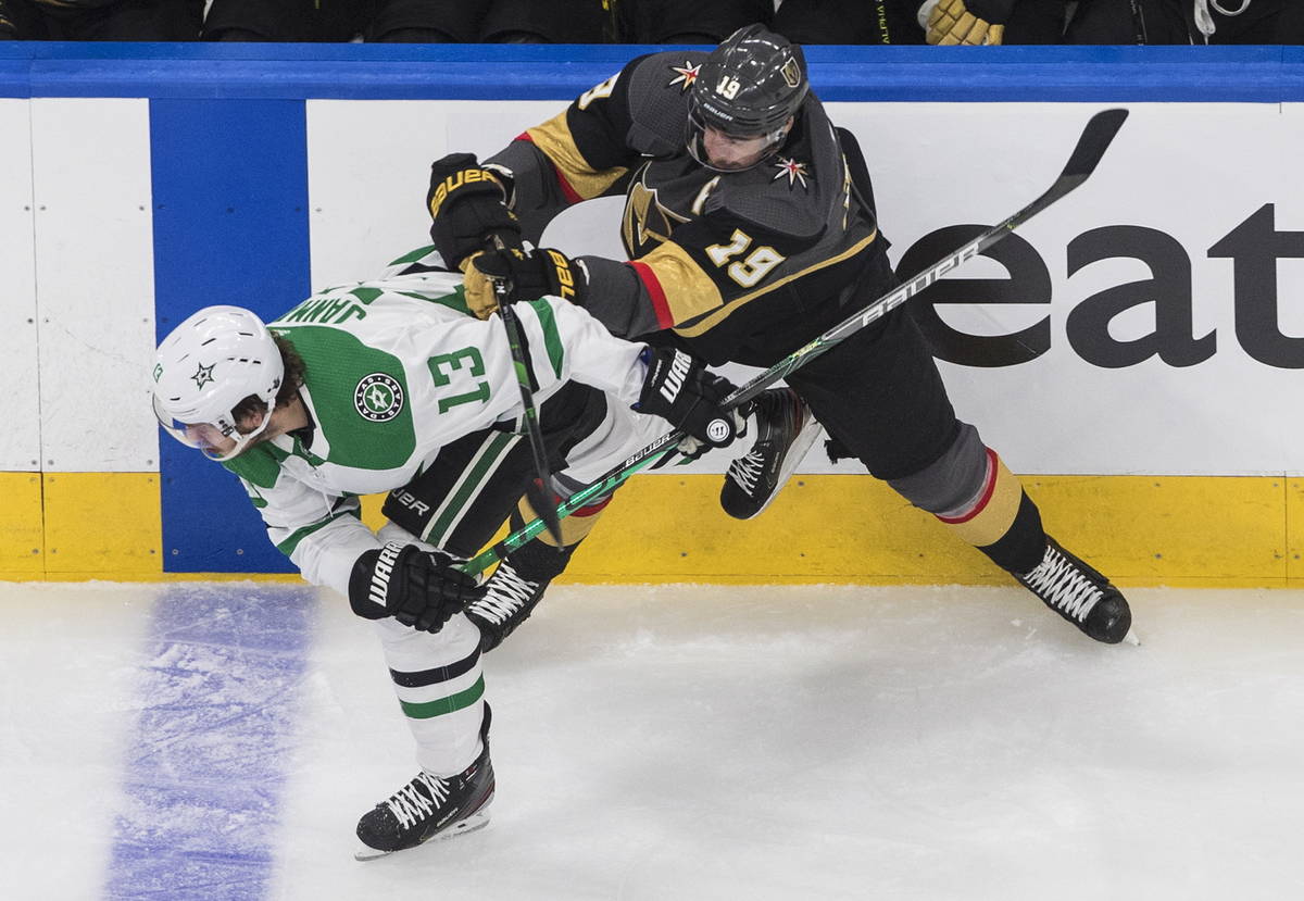 Dallas Stars' Mattias Janmark (13) is checked by Vegas Golden Knights' Reilly Smith (19) during ...