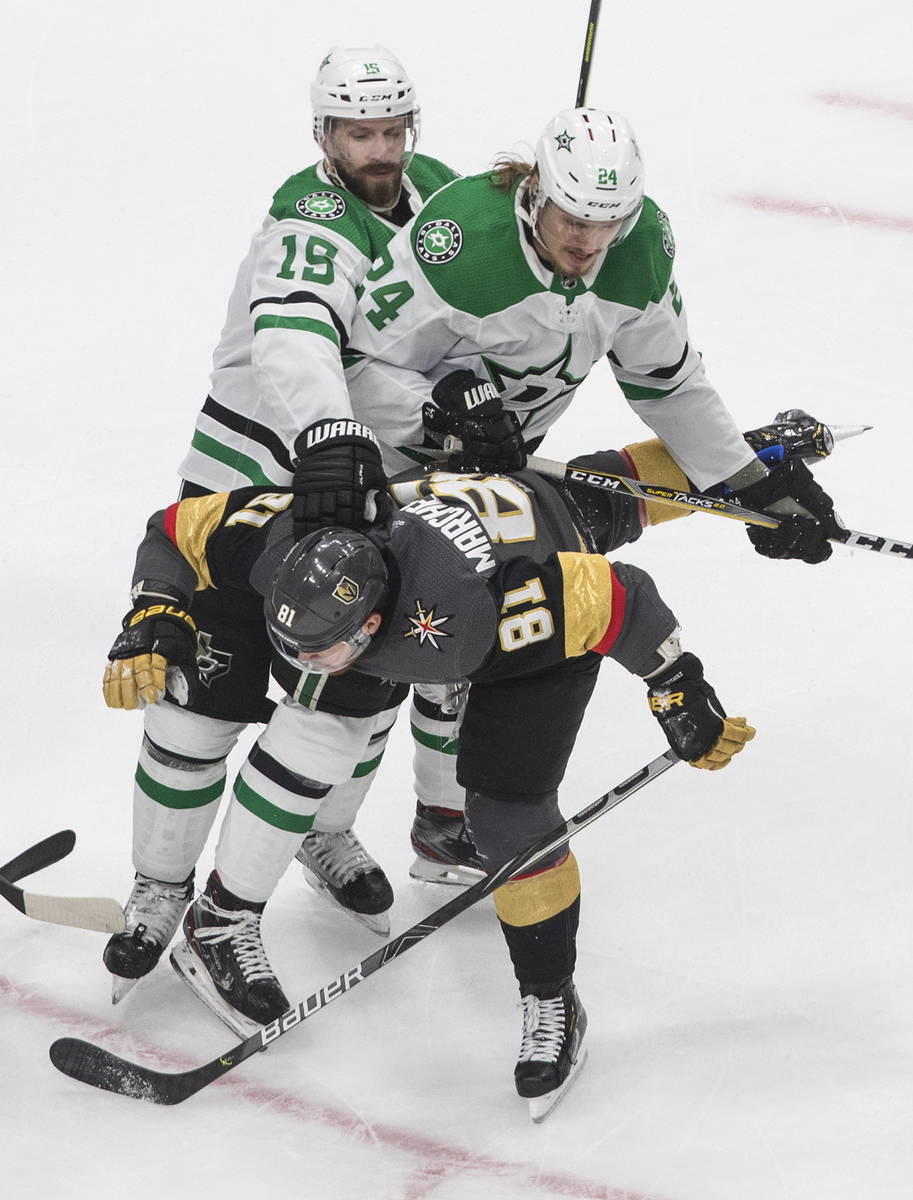 Dallas Stars' Blame Comeau (15) and Roope Hintz (24) rough up Vegas Golden Knights' Jonathan Ma ...