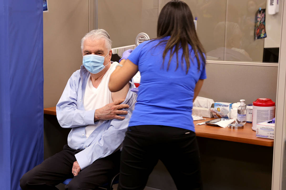 Gov. Steve Sisolak gets a flu shot from registered nurse Community Health Nurse Supervisor Mee ...