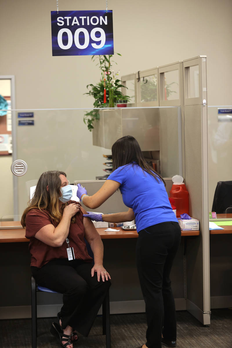 Clark County Commission Chairwoman Marilyn Kirkpatrick gets a flu shot from registered nurse Co ...