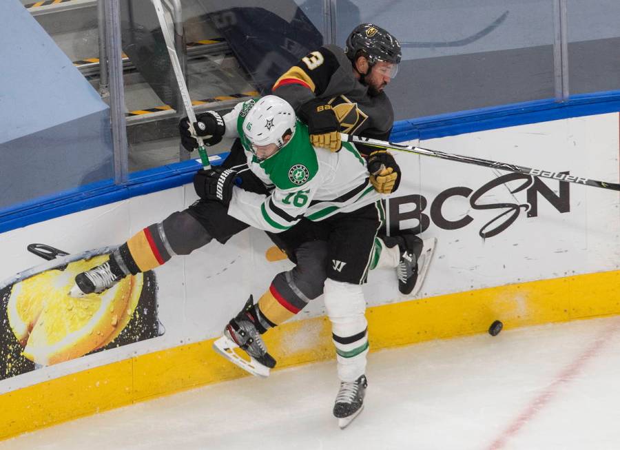 Dallas Stars' Joe Pavelski (16) checks Vegas Golden Knights' Alec Martinez (23) during the thir ...