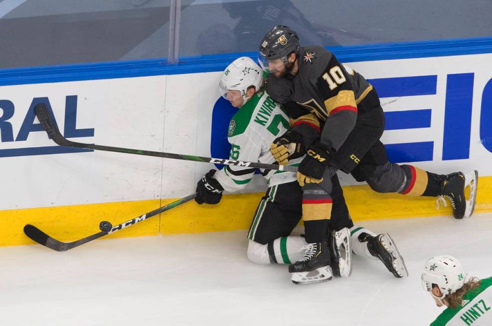 Dallas Stars' Joel Kiviranta (25) is checked by Vegas Golden Knights' Nicolas Roy (10) during t ...