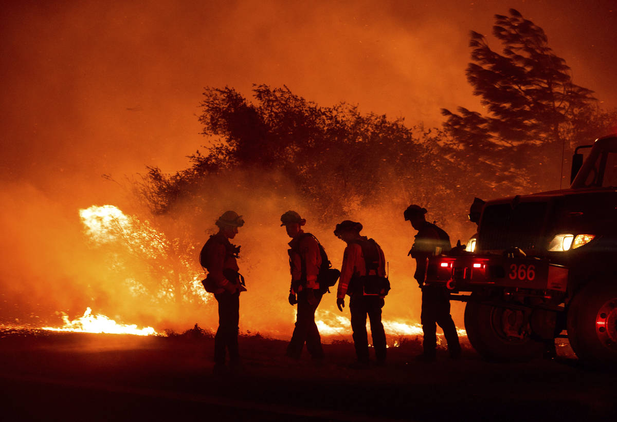Firefighters monitor the Bear Fire burning in Oroville, Calif., on Wednesday, Sept. 9, 2020. Th ...