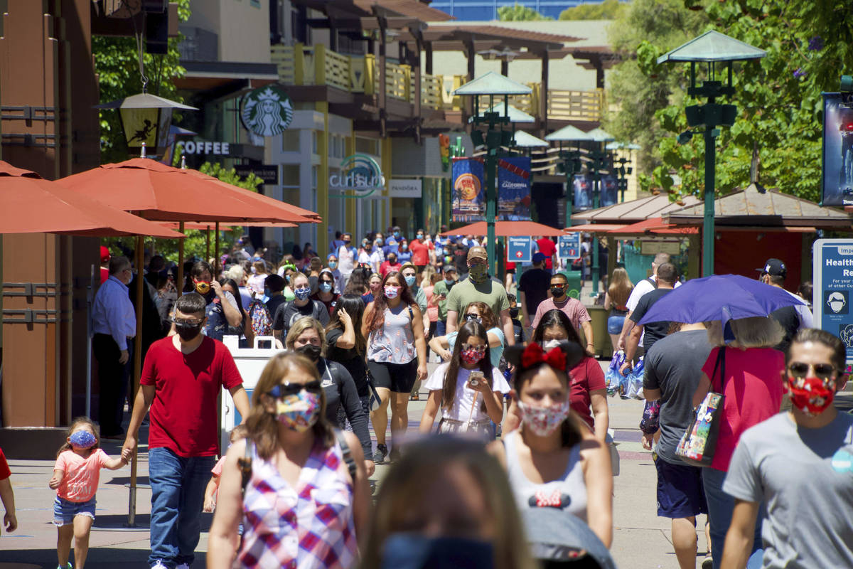 FILE - In this July 9, 2020, file photo, guests at the Disneyland Resort visit the Downtown Dis ...