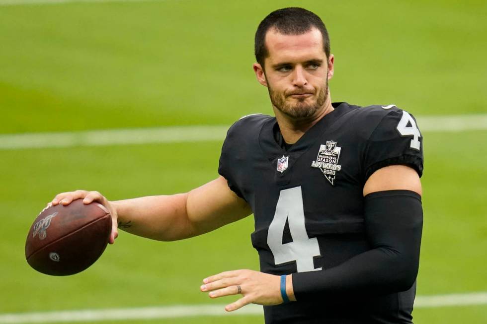 Las Vegas Raiders quarterback Derek Carr (4) throws a pass during an NFL football training camp ...