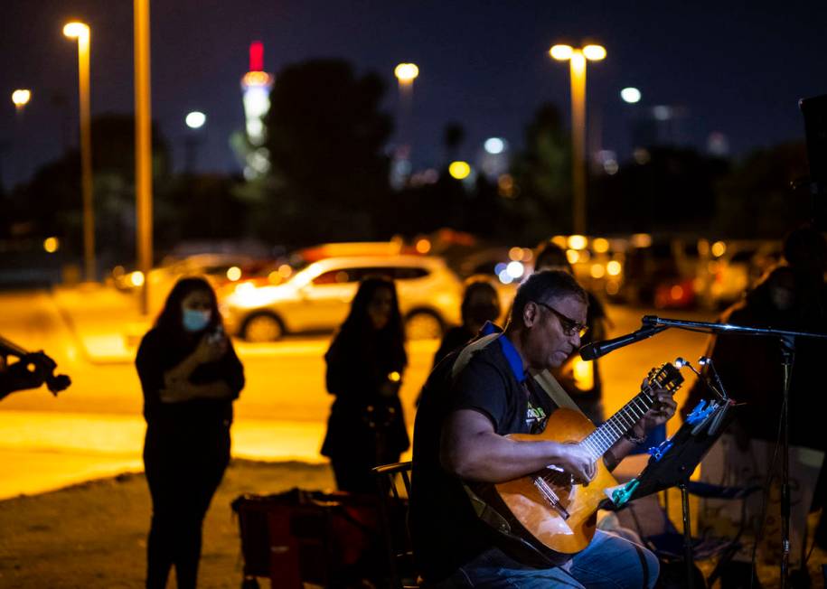 Musician John Scott performs a tribute to Jorge Gomez during a candlelight vigil in his memory ...
