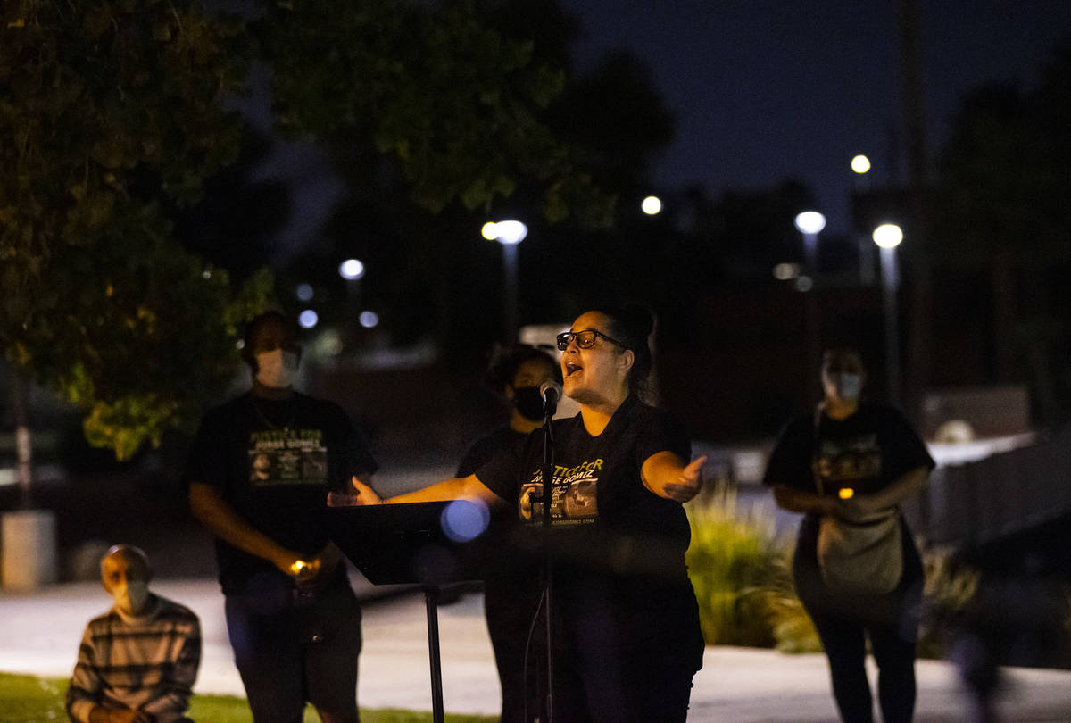 Vanessa Latrice recites a poem she wrote during a candlelight vigil for Jorge Gomez and others ...