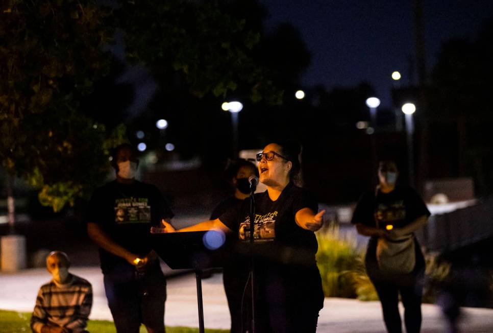 Vanessa Latrice recites a poem she wrote during a candlelight vigil for Jorge Gomez and others ...