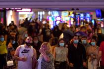 People mill around Harrah's on the Las Vegas Strip during Labor Day weekend, Sept. 5, 2020. (El ...
