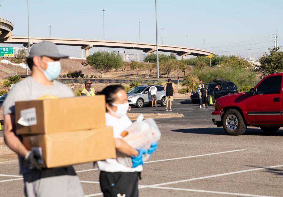 People line up at the new drive-thru distribution site for Three Square, Southern Nevada's larg ...