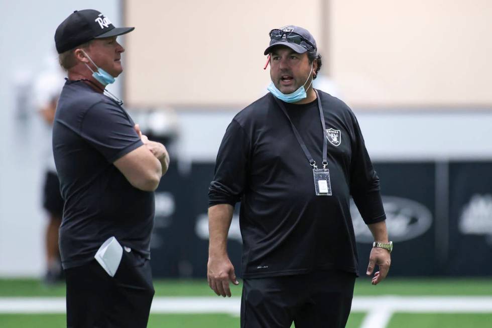 Las Vegas Raiders head coach Jon Gruden, left, talks with defensive coordinator Paul Guenther d ...