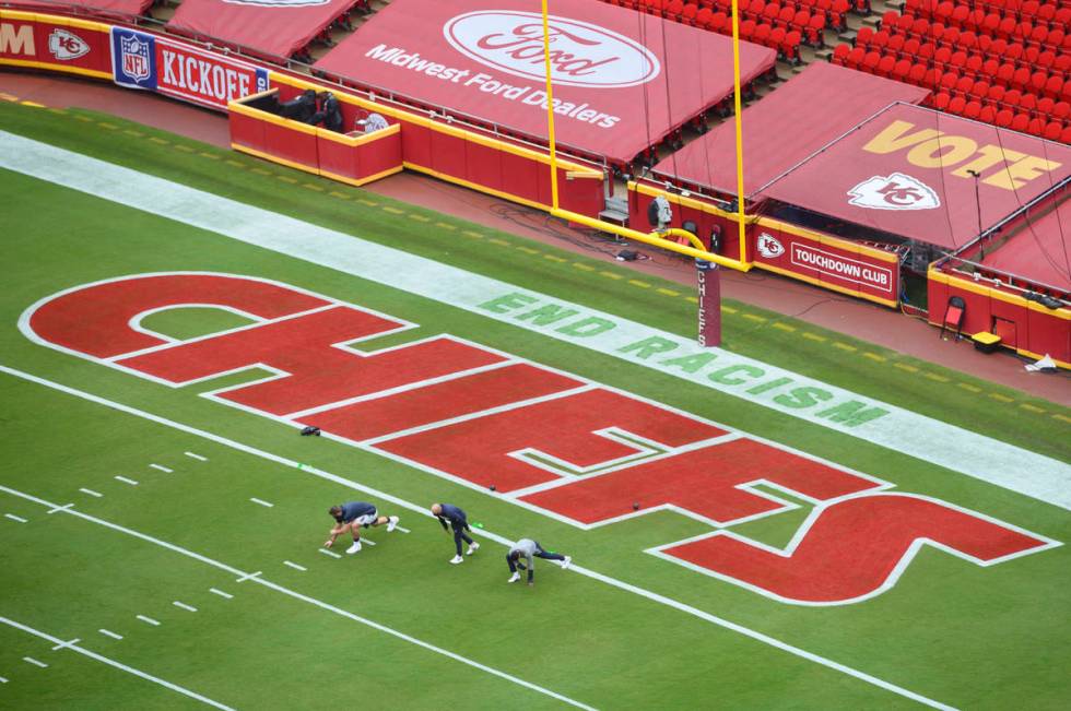 Members of the Houston Texans stretch near a social justice sign in the end zone prior to their ...