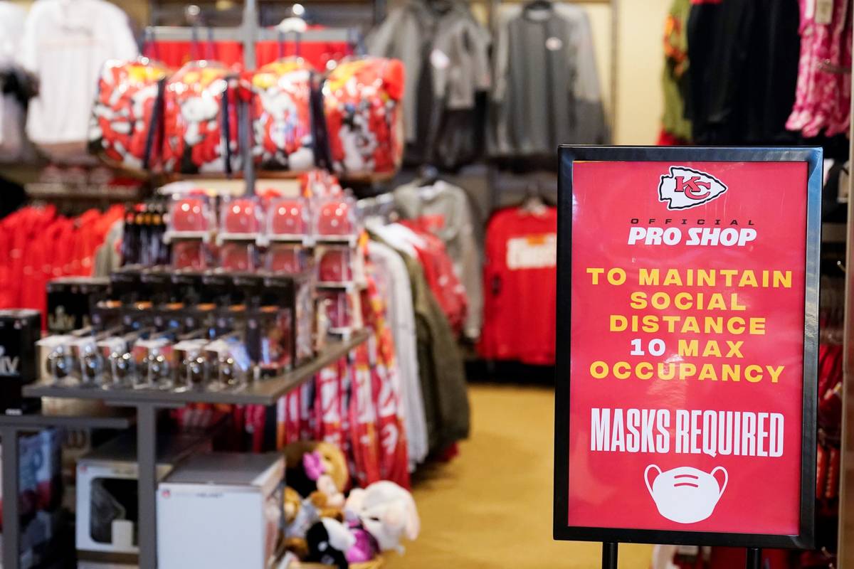 A sign reminds shoppers to keep social distance and wear masks in at souvenir shop at Arrowhead ...
