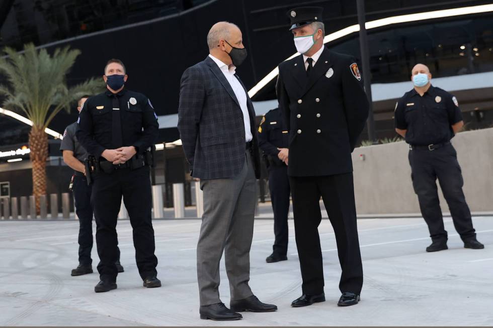 Las Vegas Raiders President Marc Badain, left, speaks to Clark County Fire Department Firefight ...