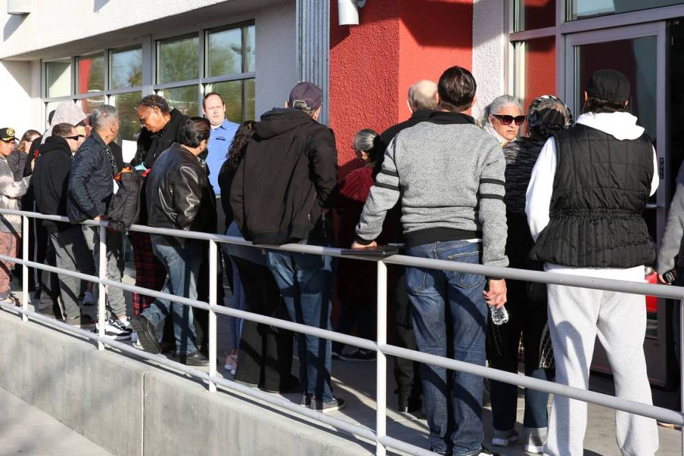 People wait in line at One-Stop Career Center on Monday, March 16, 2020, in Las Vegas. (Bizuaye ...