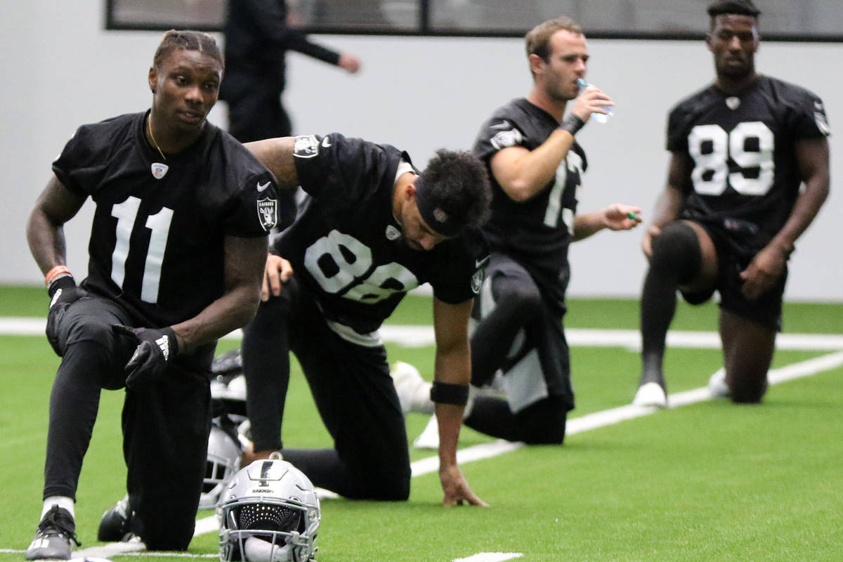 Las Vegas Raiders wide receiver Henry Ruggs III (11) stretches near wide receivers Marcell Atem ...