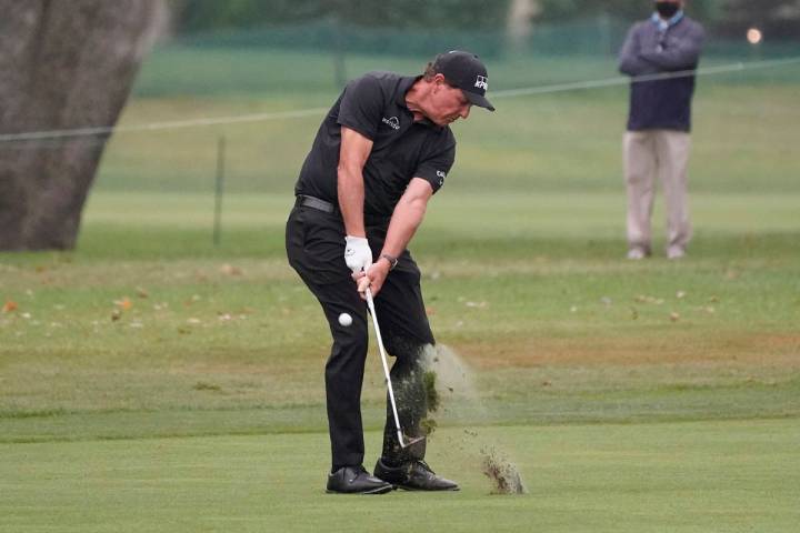 Phil Mickelson hits his approach shot to the 18th green of the Silverado Resort North Course du ...