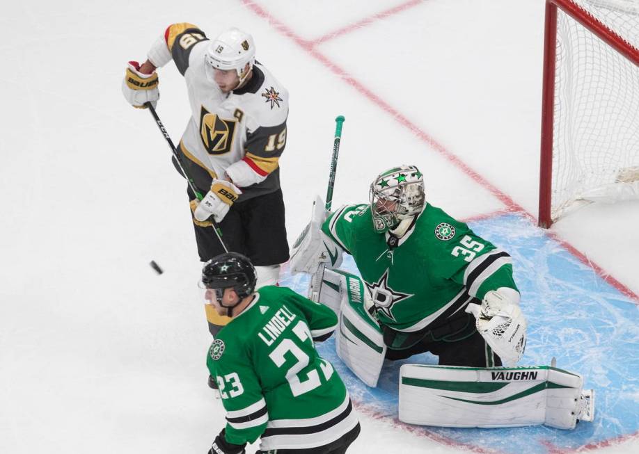 Dallas Stars goalie Anton Khudobin (35) makes a save as Vegas Golden Knights' Reilly Smith (19) ...