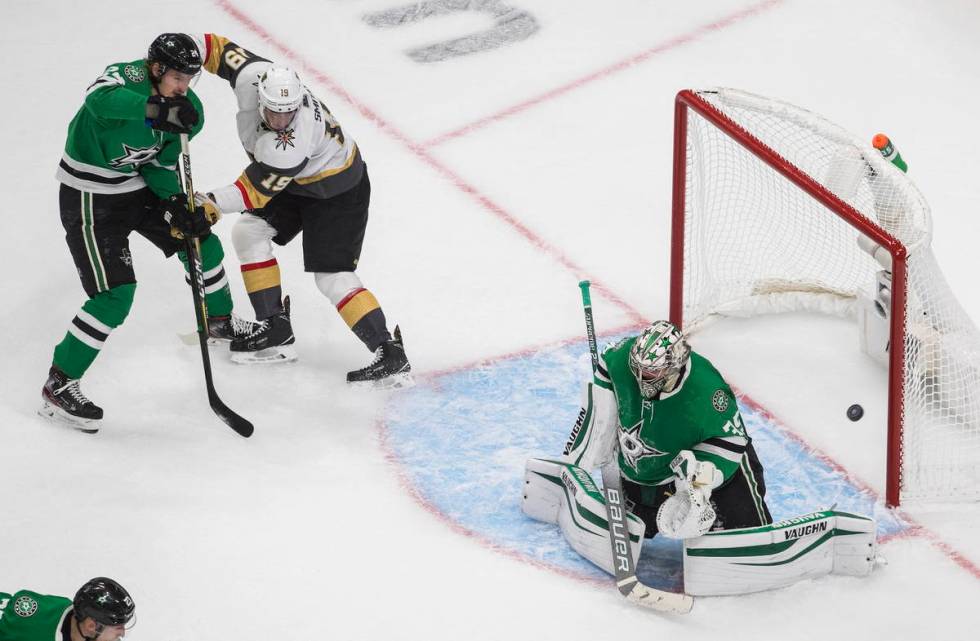 Dallas Stars goalie Anton Khudobin (35) makes a save as Vegas Golden Knights' Reilly Smith (19) ...