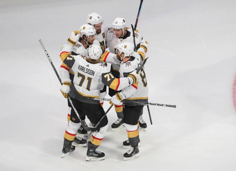 Vegas Golden Knights' Shea Theodore (27) celebrates his goal against the Dallas Stars with team ...