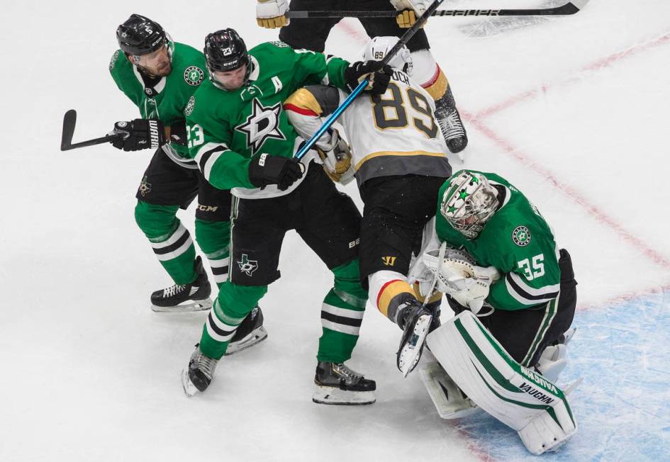 Dallas Stars goalie Anton Khudobin (35) makes a save as Vegas Golden Knights' Alex Tuch (89) an ...