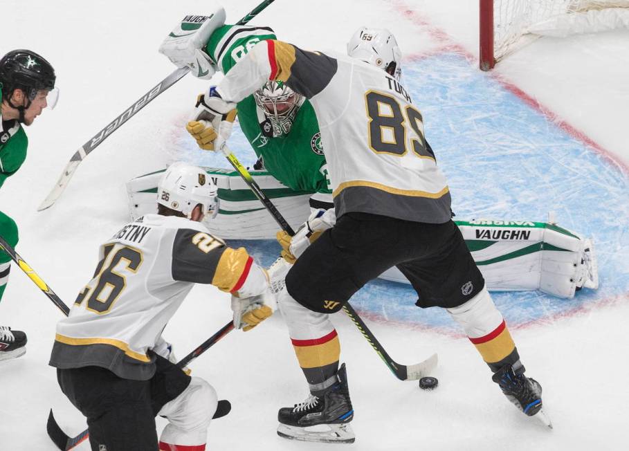 Dallas Stars goalie Anton Khudobin (35) makes a save on Vegas Golden Knights' Alex Tuch (89) du ...