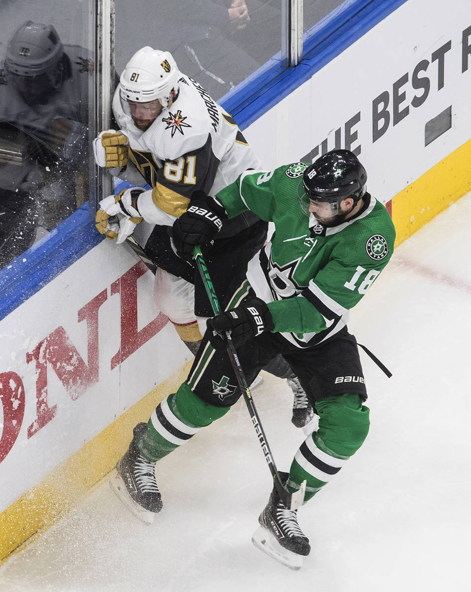 Dallas Stars' Jason Dickinson (18) checks Vegas Golden Knights' Jonathan Marchessault (81) duri ...