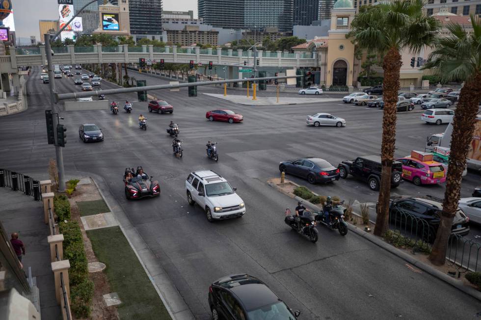 A caravan of motorcycles with American flags are seen driving down the Las Vegas Strip on Frida ...