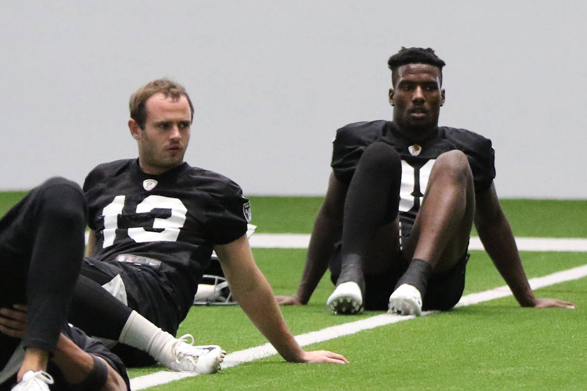 Las Vegas Raiders wide receivers Hunter Renfrow (13) and Bryan Edwards (89) stretch next to eac ...