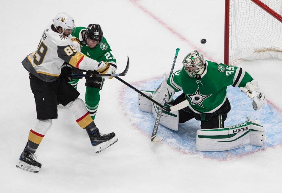 Dallas Stars goalie Anton Khudobin (35) makes a save on Vegas Golden Knights' Alex Tuch (89) as ...