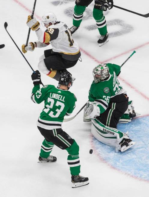 Dallas Stars goalie Anton Khudobin (35) makes a save as Vegas Golden Knights' Reilly Smith (19) ...