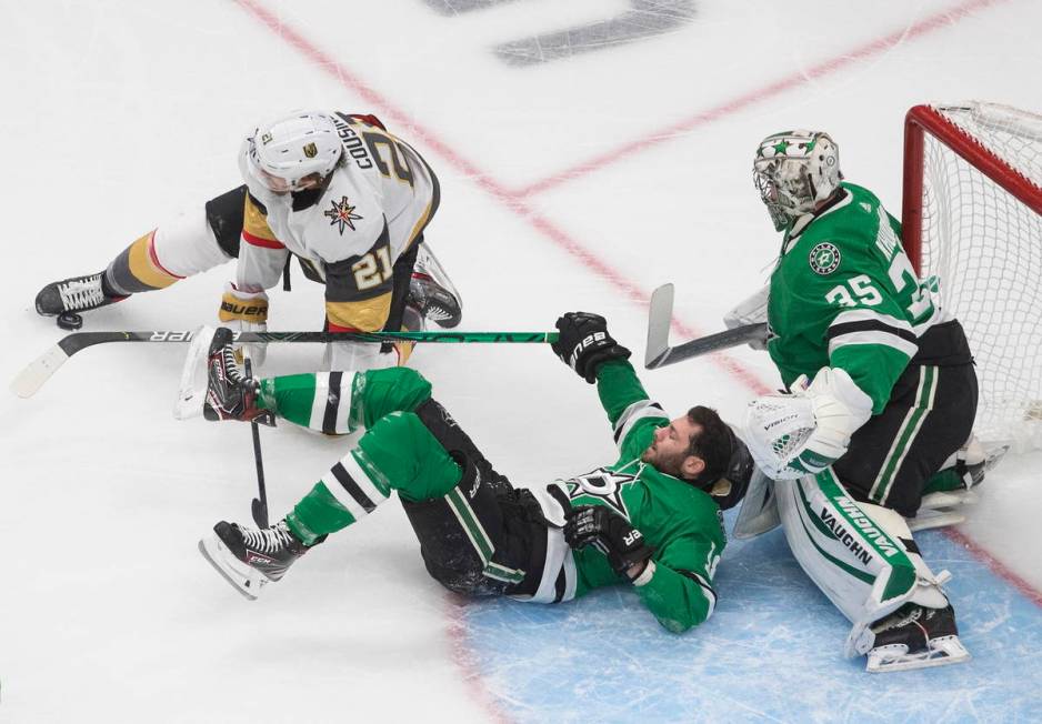 Dallas Stars goalie Anton Khudobin (35) makes a save as Vegas Golden Knights center Nick Cousin ...