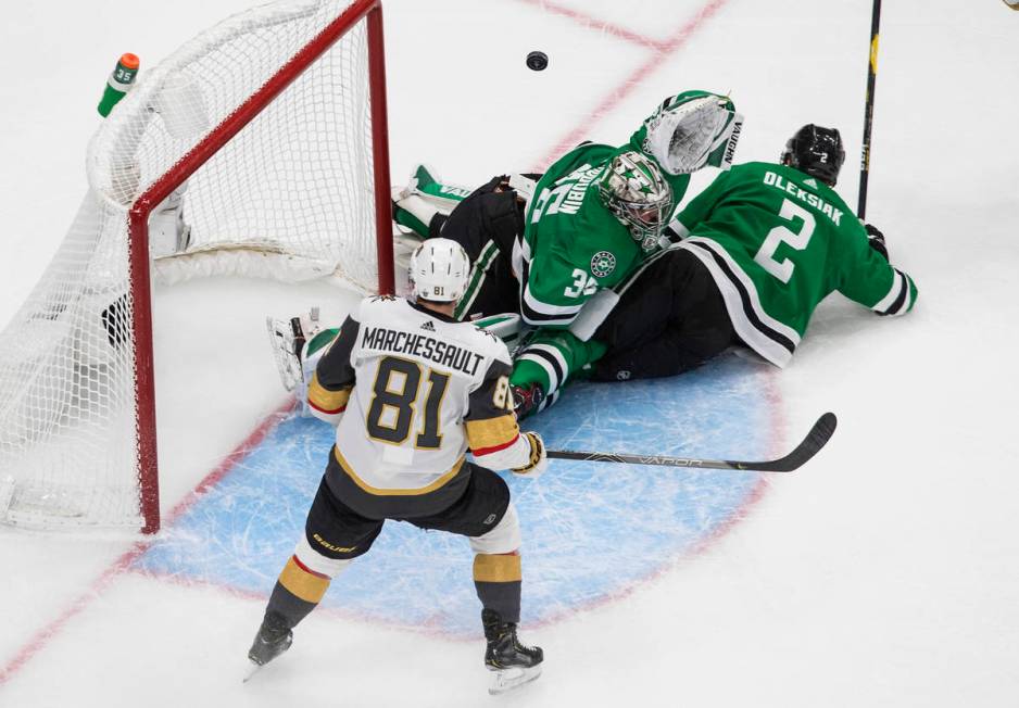 Dallas Stars goalie Anton Khudobin (35) makes the save as Vegas Golden Knights' Jonathan Marche ...