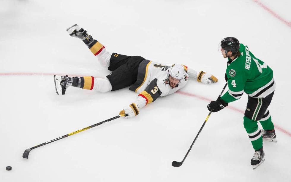 Vegas Golden Knights defenseman Brayden McNabb (3) reaches for the puck in front of Dallas Star ...