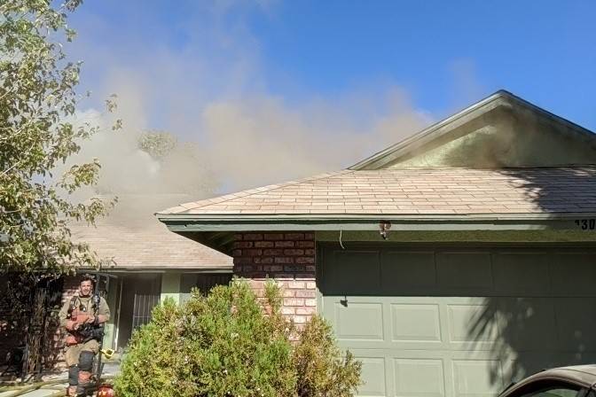 Crews battle a blaze at a house on Woodbridge Drive in Las Vegas on Saturday. (Las Vegas Fire D ...