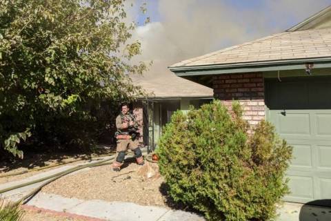Crews battle a blaze at a house on Woodbridge Drive in Las Vegas on Saturday. (Las Vegas Fire D ...