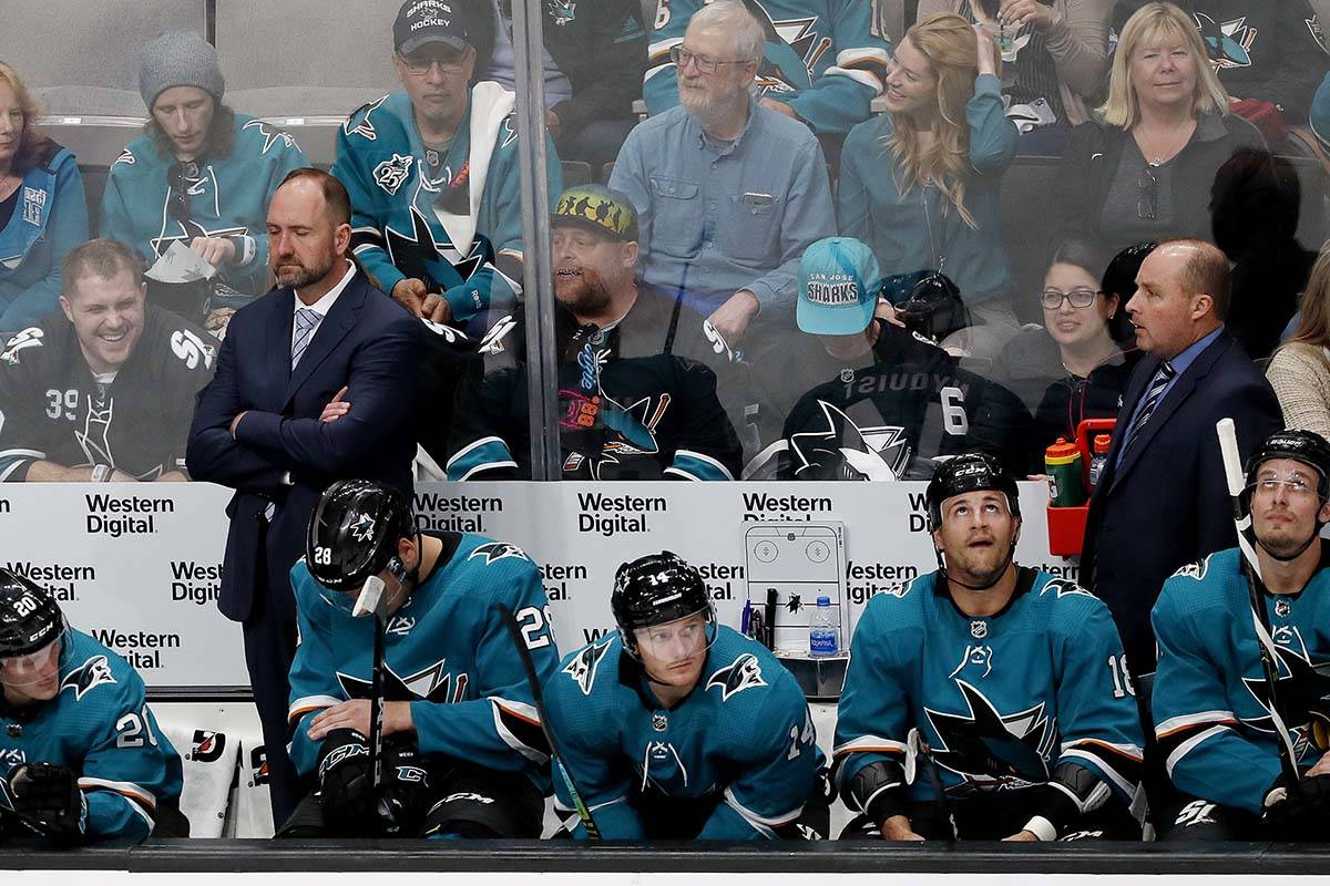 San Jose Sharks coach Peter DeBoer, left rear, stands in the bench area during the second perio ...