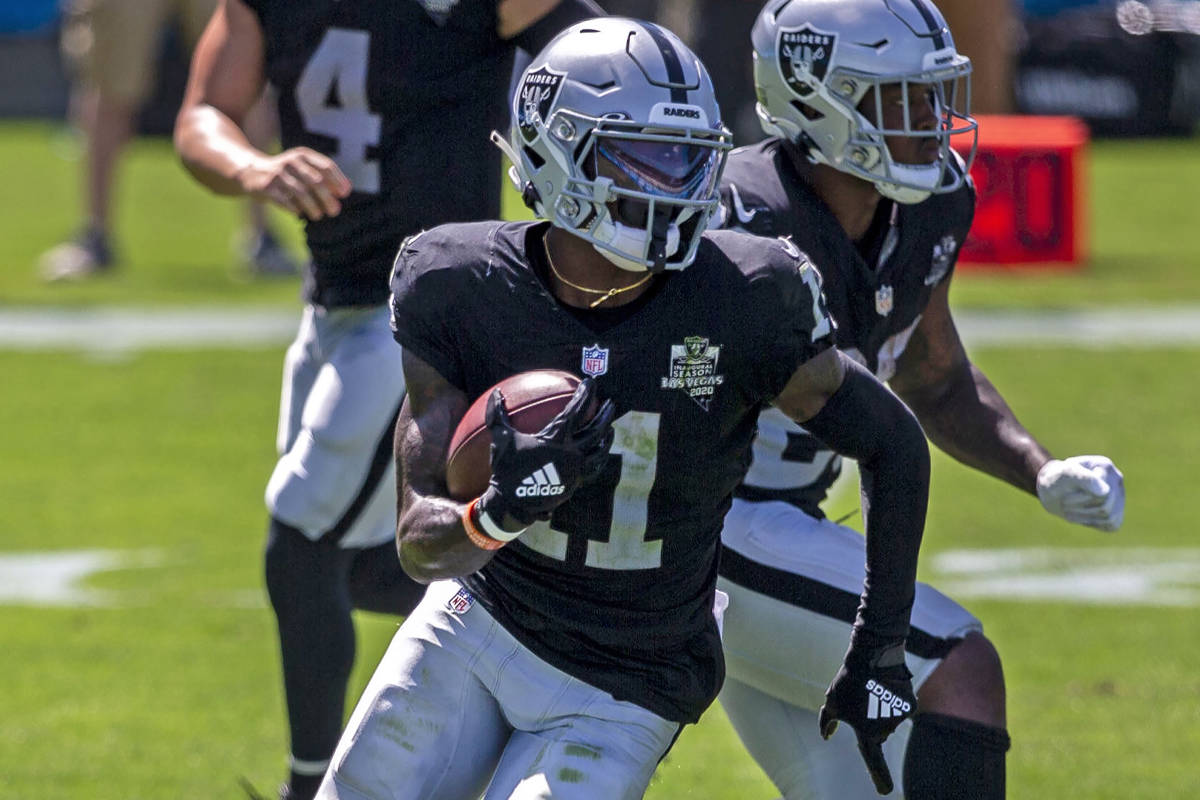 Las Vegas Raiders wide receiver Henry Ruggs III (11) runs with the football on a reverse from L ...