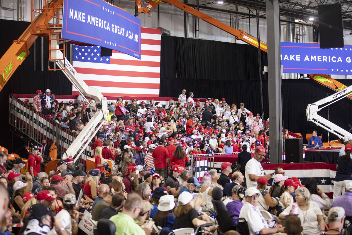 A large crowd waits for President Donald Trump at a campaign rally at Xtreme Manufacturing in H ...