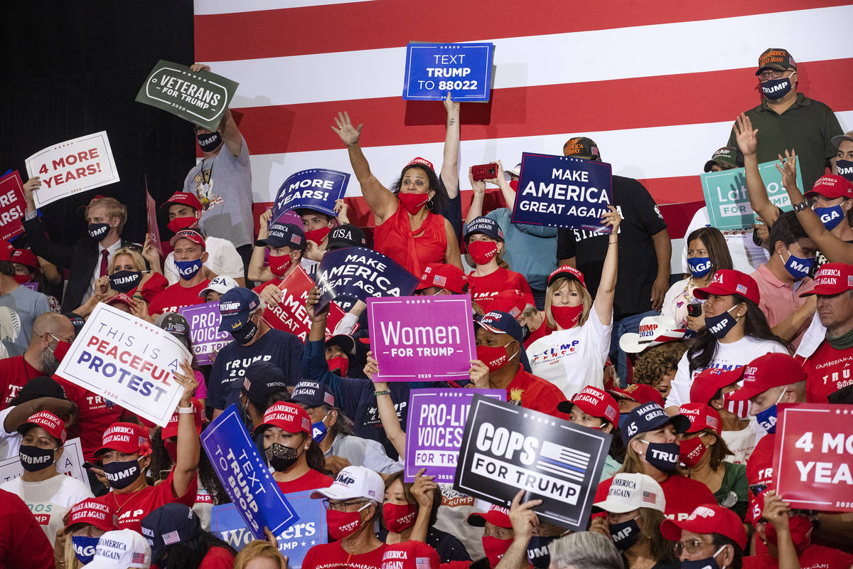 The crowd cheers while waiting for President Donald Trump to take the stage at a campaign rally ...