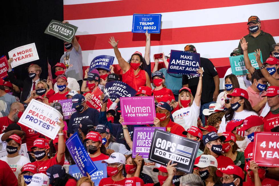 The crowd cheers while waiting for President Donald Trump to take the stage at a campaign rally ...