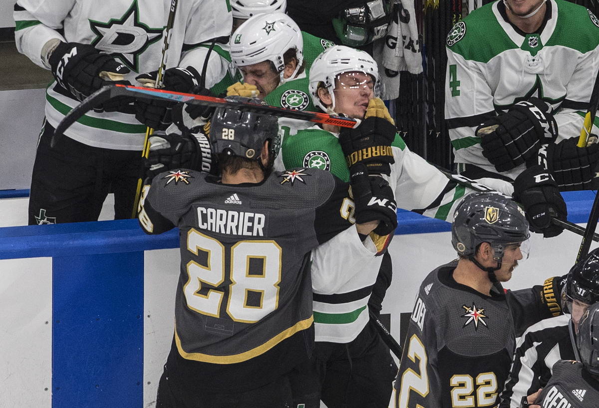 Dallas Stars' Denis Gurianov (34) and Vegas Golden Knights' William Carrier (28) rough it up du ...
