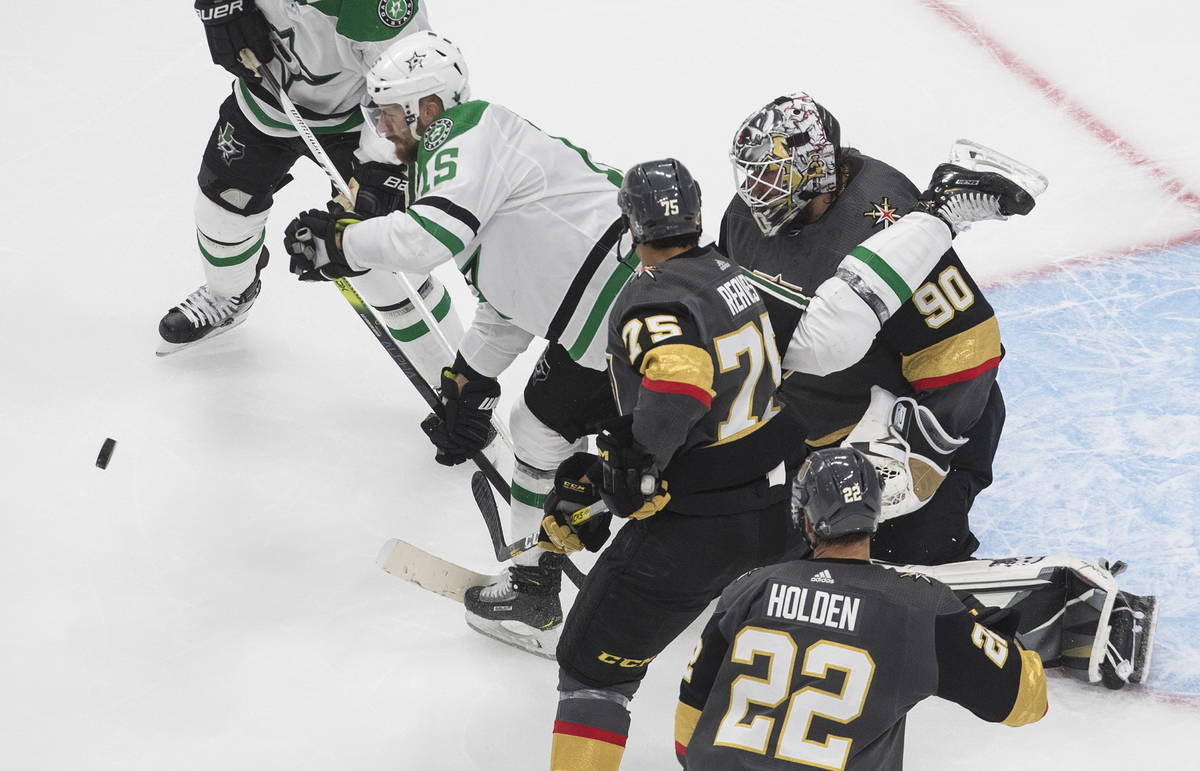 Dallas Stars' Blake Comeau (15) and Vegas Golden Knights' Ryan Reaves (75) battle for the rebou ...