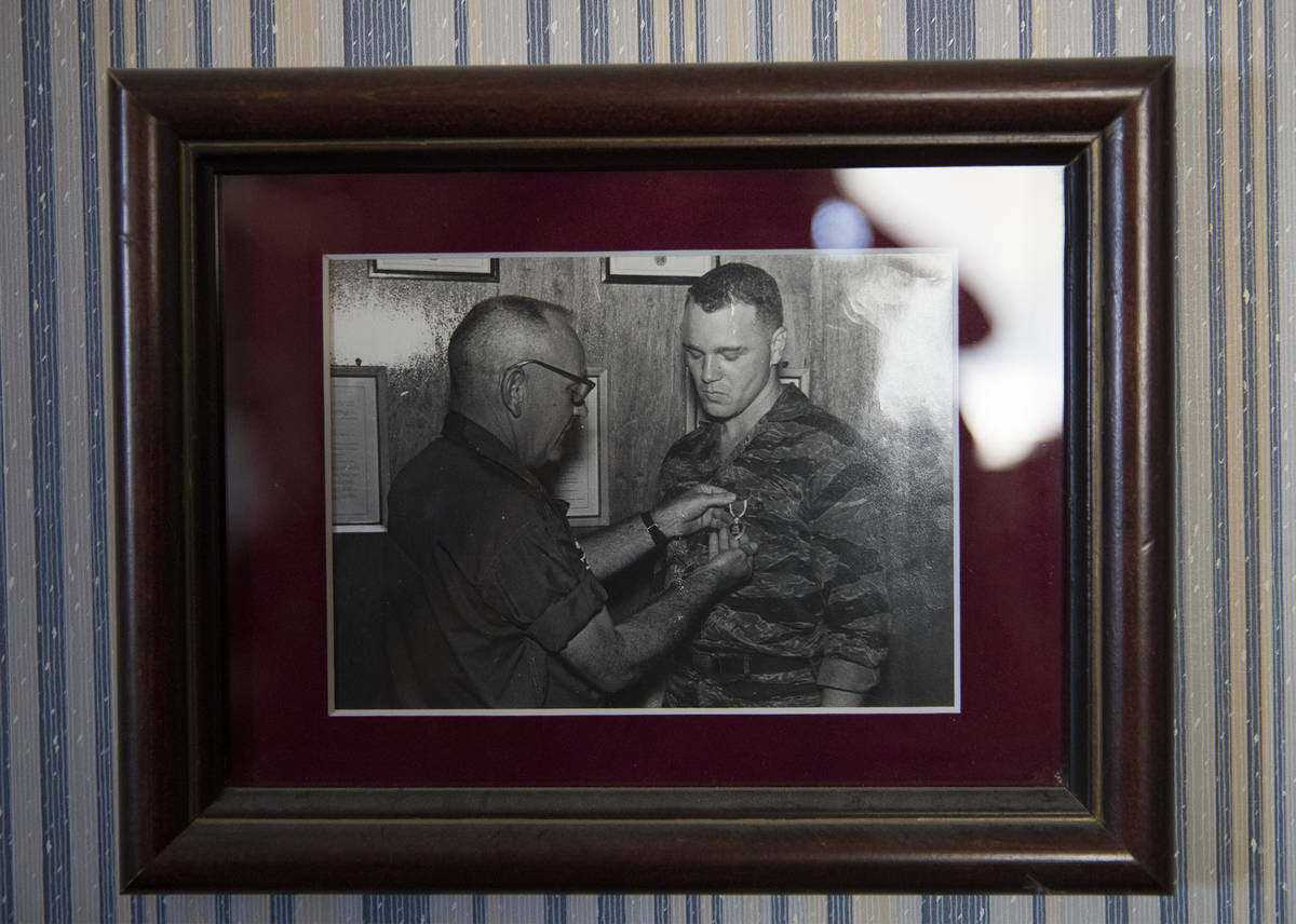 A photo of a young James “Bo” Gritz, a former U.S. Army Special Forces officer, right, bein ...