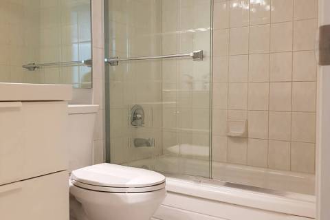 Most doors on tub enclosures hang from the top rail and slide along its guide track. (Getty Images)