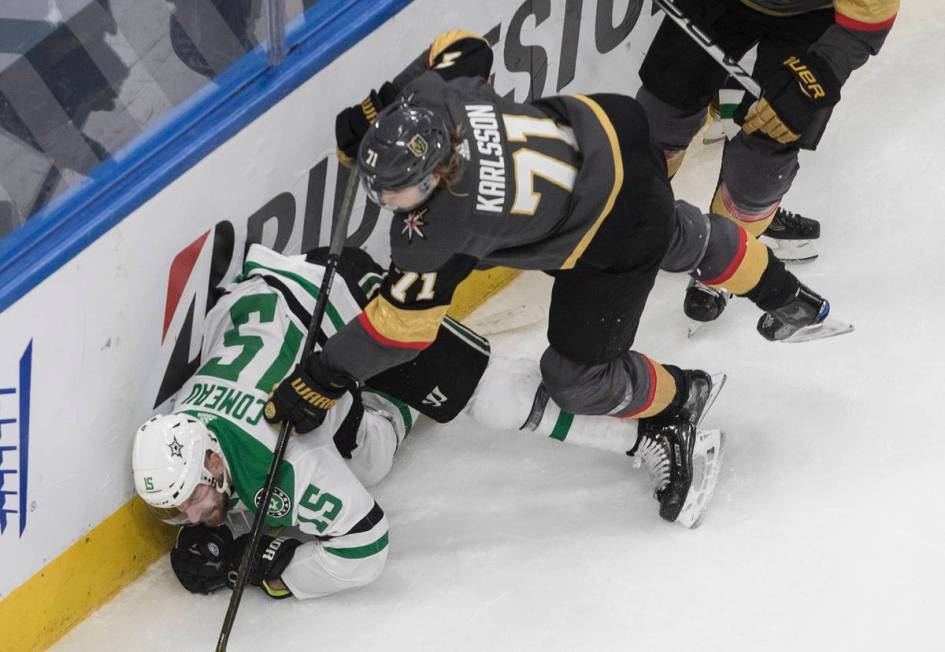 Dallas Stars' Blake Comeau (15) is checked by Vegas Golden Knights' William Karlsson (71) durin ...