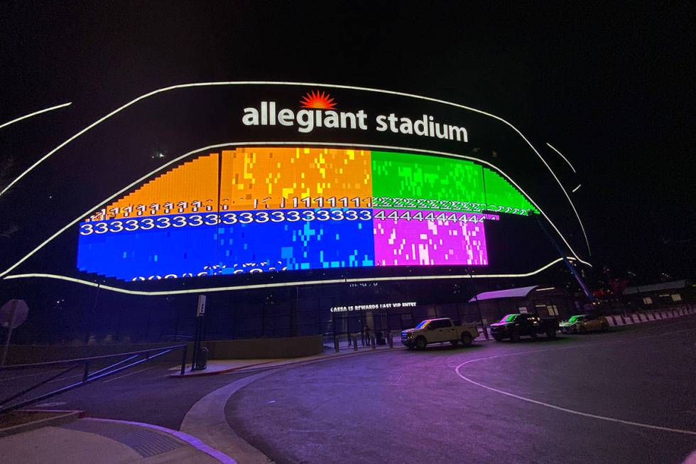 The massive video board lit up on the Interstate 15 facing portion of Allegiant Stadium. (Mick ...