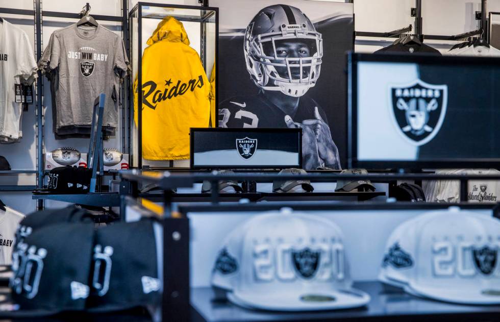 A classic gold and black RaiderÕs jacket is on display amongst merchandise to purchase at ...
