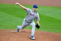New York Mets starting pitcher Seth Lugo throws to a Toronto Blue Jays batter during the first ...